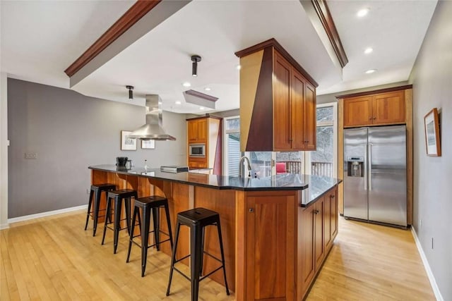 71 Waterfront Dr, Washingtons Landing, PA 15222 - kitchen with appliances with stainless steel finishes, island exhaust hood, light wood-style flooring, brown cabinets, and recessed lighting