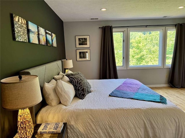 71 Waterfront Dr, Washingtons Landing, PA 15222 - bedroom with wood finished floors, recessed lighting, and a textured ceiling