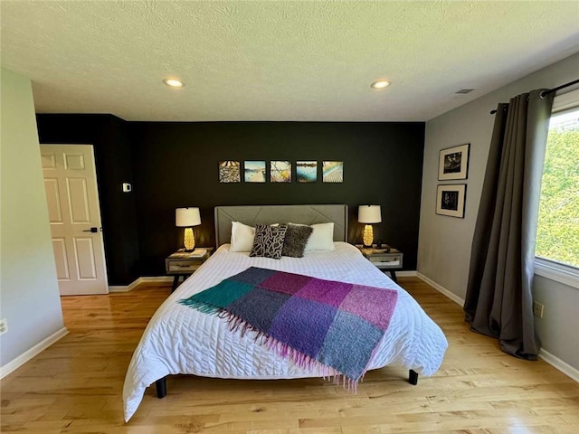 71 Waterfront Dr, Washingtons Landing, PA 15222 - bedroom with wood finished floors, a textured ceiling, and recessed lighting