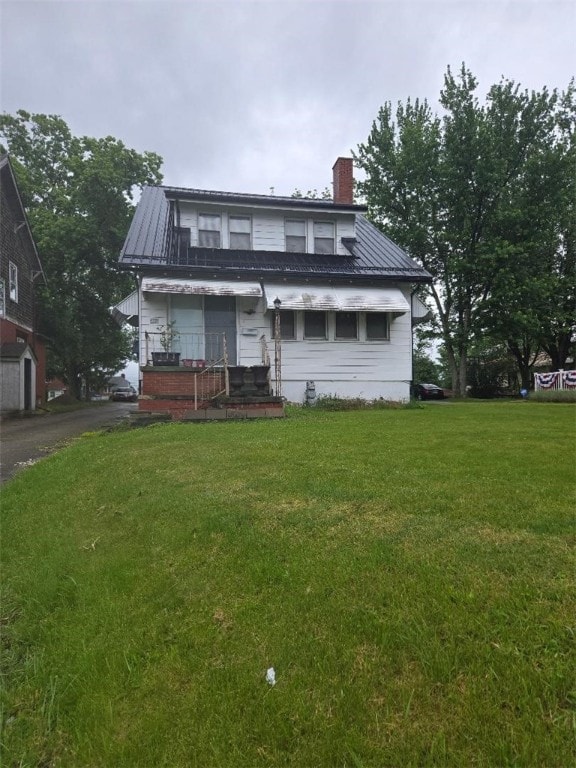 615 Morgantown Rd, South Union Twp, PA 15401 - view of front of house featuring a chimney, a front lawn, and a metal roof