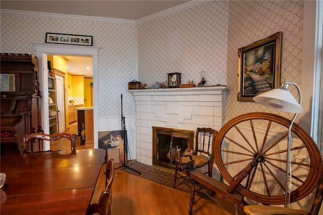 200 School St, Green Tree, PA 15220 - living area with wallpapered walls, wood finished floors, crown molding, and a brick fireplace