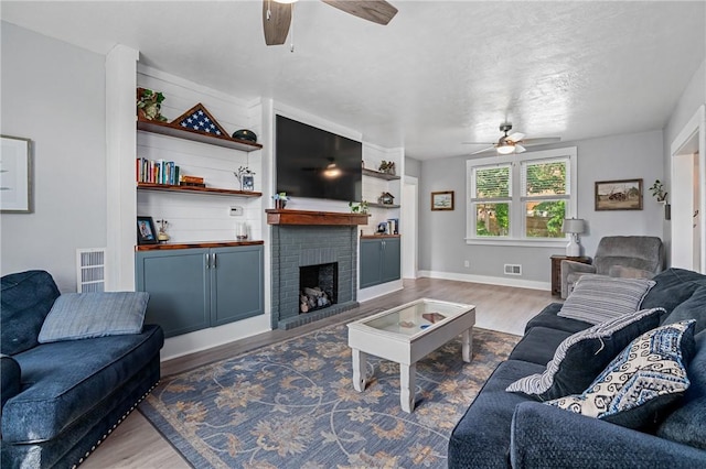 401 Stanford Ave, Ross Twp, PA 15229 - living area with a ceiling fan, wood finished floors, and a fireplace