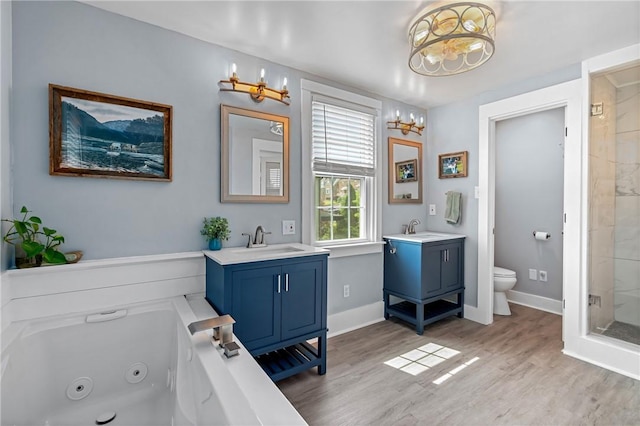 401 Stanford Ave, Ross Twp, PA 15229 - bathroom with a chandelier, a stall shower, two vanities, wood finished floors, and a jetted tub