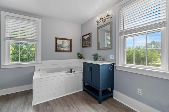 401 Stanford Ave, Ross Twp, PA 15229 - full bath with vanity, a garden tub, wood finished floors, and healthy amount of natural light