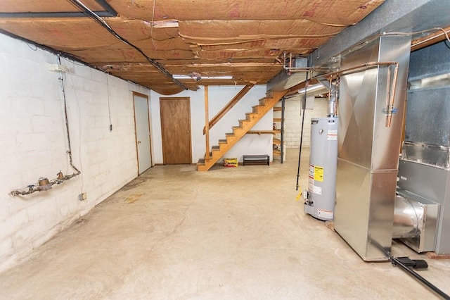 408 Victor Dr, South Union Twp, PA 15401 - unfinished basement featuring water heater, heating unit, stairway, and concrete block wall