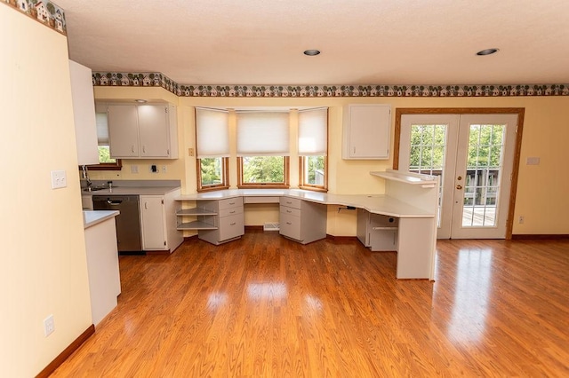 408 Victor Dr, South Union Twp, PA 15401 - kitchen with stainless steel dishwasher, light wood-style floors, light countertops, built in study area, and recessed lighting