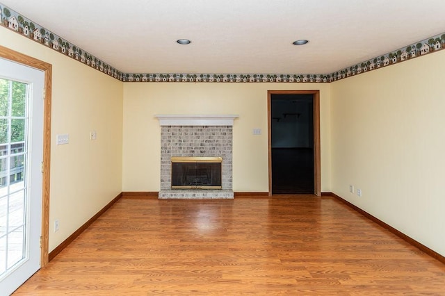408 Victor Dr, South Union Twp, PA 15401 - unfurnished living room featuring light wood finished floors, a brick fireplace, and recessed lighting