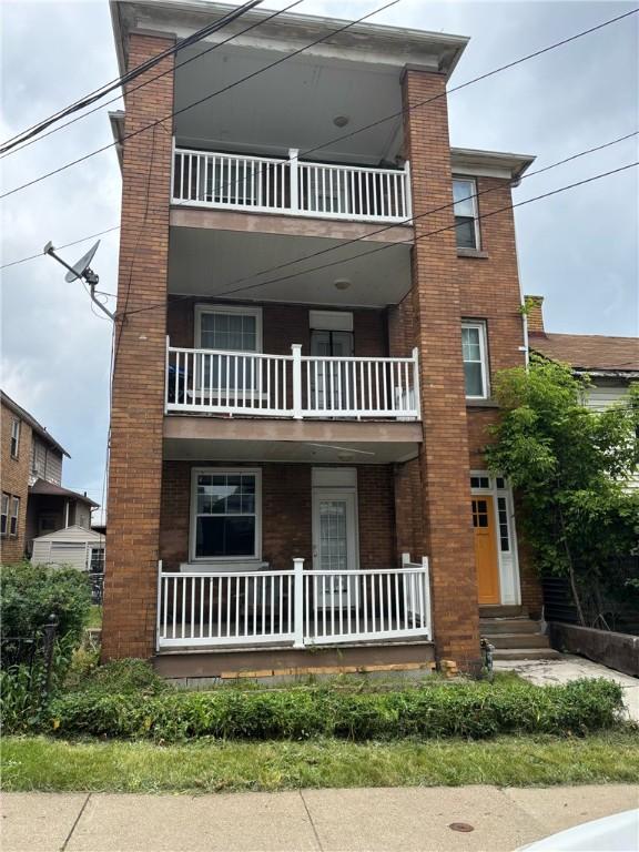 107 E 18th Ave, Homestead, PA 15120 - view of front of house with a porch and brick siding