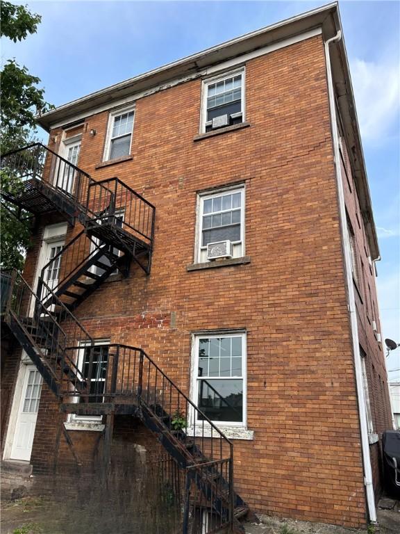 107 E 18th Ave, Homestead, PA 15120 - view of building exterior with stairs and cooling unit