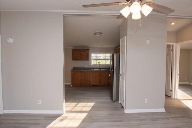 824 Emerson Ave, Farrell, PA 16121 - kitchen featuring freestanding refrigerator, ceiling fan, brown cabinets, light wood-style floors, and crown molding