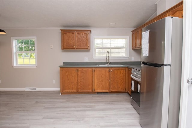 824 Emerson Ave, Farrell, PA 16121 - kitchen featuring appliances with stainless steel finishes, crown molding, brown cabinetry, and light wood-style flooring