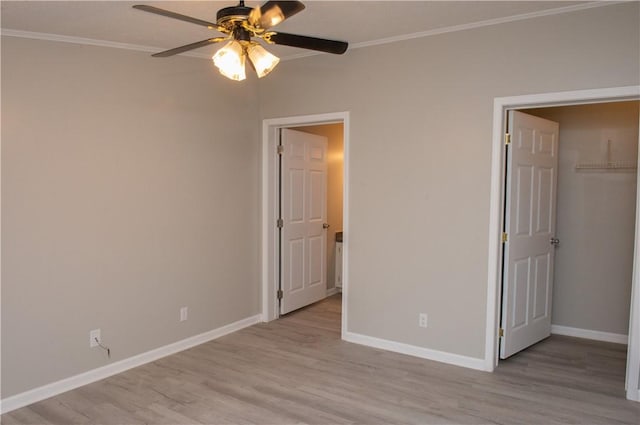 824 Emerson Ave, Farrell, PA 16121 - unfurnished bedroom featuring ornamental molding, light wood finished floors, a closet, ceiling fan, and a walk in closet