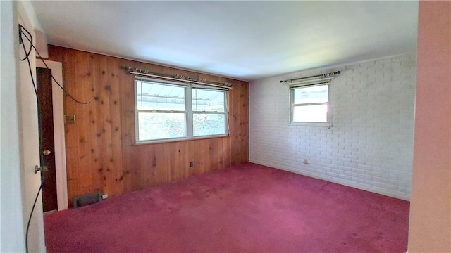 93 8th Ave, Ross Twp, PA 15229 - unfurnished room featuring wooden walls, carpet floors, and brick wall