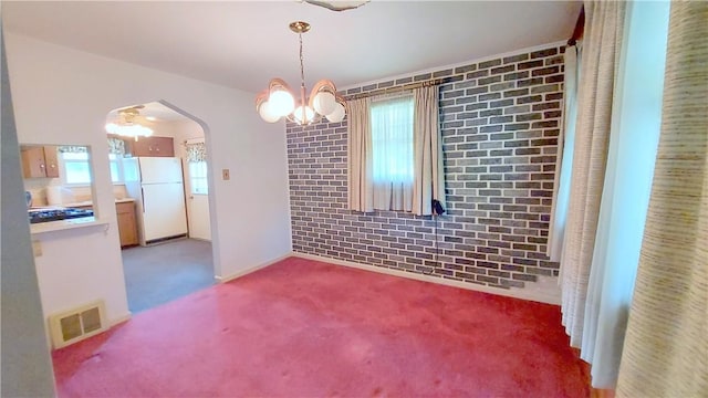 93 8th Ave, Ross Twp, PA 15229 - unfurnished dining area featuring a chandelier, arched walkways, carpet, and brick wall