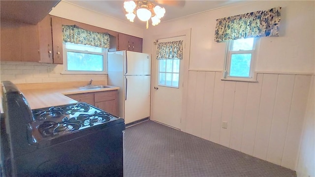 93 8th Ave, Ross Twp, PA 15229 - kitchen featuring freestanding refrigerator, black range with gas stovetop, a ceiling fan, wainscoting, and light countertops