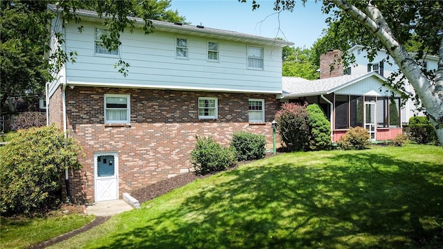 123 W Muntz Ave, Twp Of But Se, PA 16001 - rear view of house with a sunroom, a yard, and brick siding