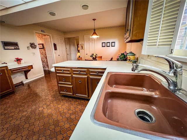 123 W Muntz Ave, Twp Of But Se, PA 16001 - kitchen featuring a peninsula, hanging light fixtures, light countertops, and brown cabinets