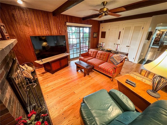 123 W Muntz Ave, Twp Of But Se, PA 16001 - living room with a fireplace with raised hearth, beam ceiling, wood-type flooring, wooden walls, and a ceiling fan