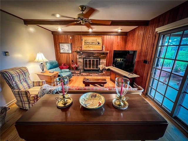 123 W Muntz Ave, Twp Of But Se, PA 16001 - living area with a glass covered fireplace, wood finished floors, wood walls, ceiling fan, and beam ceiling