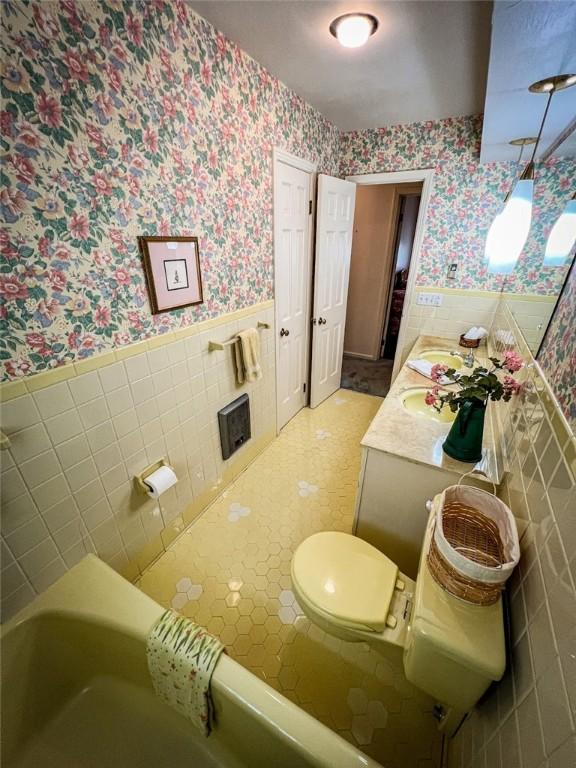 123 W Muntz Ave, Twp Of But Se, PA 16001 - full bathroom with wallpapered walls, tile walls, a wainscoted wall, and double vanity