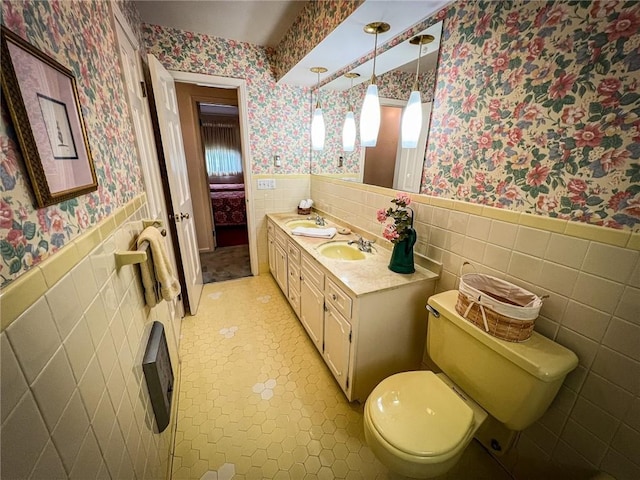 123 W Muntz Ave, Twp Of But Se, PA 16001 - bathroom featuring wallpapered walls, tile walls, a wainscoted wall, and double vanity