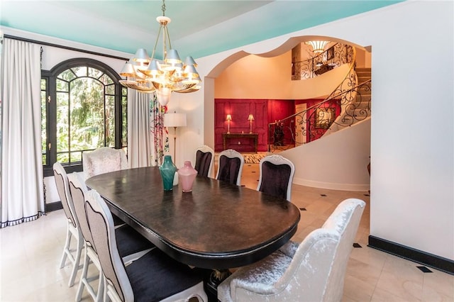 99 Wiggins Ln, South Union Twp, PA 15401 - dining room with a chandelier, arched walkways, healthy amount of natural light, and stairs