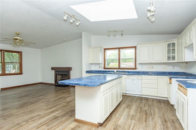 400 Moween Rd, Loyalhanna, PA 15681 - kitchen featuring white dishwasher, vaulted ceiling, a center island, a skylight, and light wood-style flooring
