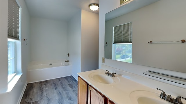 3011 Meyeridge Rd, Shaler, PA 15209 - bathroom with a bath, double vanity, healthy amount of natural light, and wood finished floors