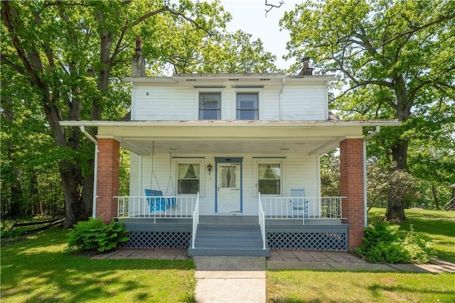11 Old Mill Rd, Wharton Twp, PA 15470 - american foursquare style home with a chimney, covered porch, and a front lawn