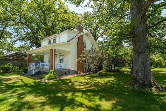 11 Old Mill Rd, Wharton Twp, PA 15470 - view of front of home featuring a porch, a chimney, and a front lawn
