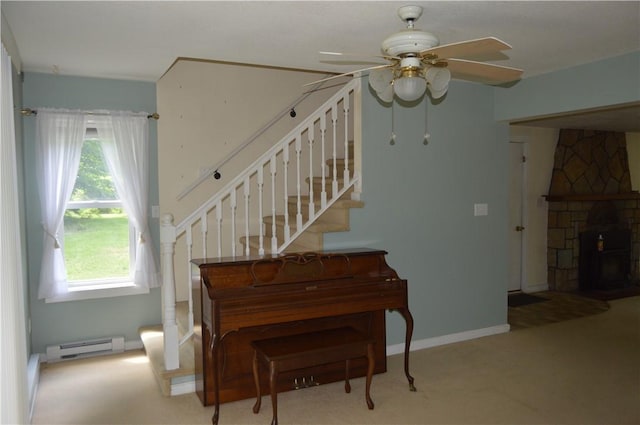 3244 Maple Ln, Jamestown Cra, PA 16134 - stairway with baseboard heating, carpet, a ceiling fan, and a stone fireplace