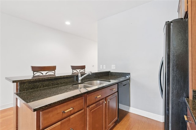 151 Fort Pitt Blvd Unit 1403, Downtown Pgh, PA 15222 - kitchen with freestanding refrigerator, light wood-type flooring, dark stone counters, a peninsula, and dishwasher