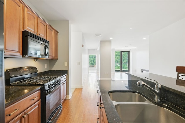 151 Fort Pitt Blvd Unit 1403, Downtown Pgh, PA 15222 - kitchen with black appliances, dark stone countertops, light wood-style flooring, and recessed lighting