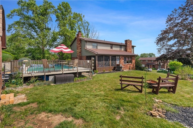 401 Middlesex Rd, Elizabeth Twp/Boro, PA 15135 - back of property featuring a chimney, a yard, a sunroom, a wooden deck, and brick siding