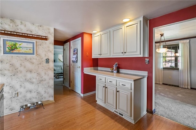 401 Middlesex Rd, Elizabeth Twp/Boro, PA 15135 - kitchen featuring light wood-style floors, light countertops, and white cabinetry