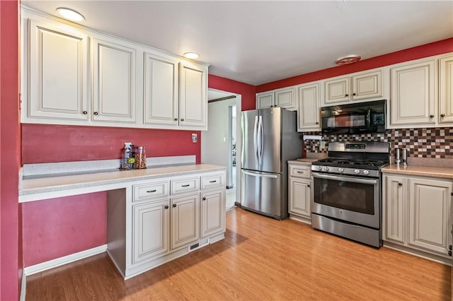 401 Middlesex Rd, Elizabeth Twp/Boro, PA 15135 - kitchen with stainless steel appliances, light wood finished floors, light countertops, and backsplash