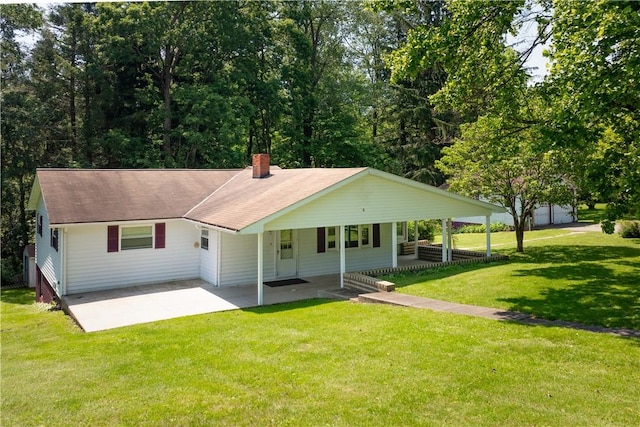 154 Burke Rd, Wharton Twp, PA 15437 - view of front of house featuring a chimney, a front lawn, roof with shingles, driveway, and a carport