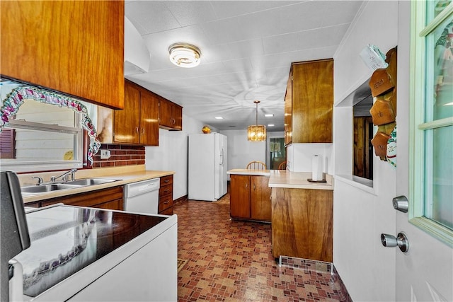 154 Burke Rd, Wharton Twp, PA 15437 - kitchen featuring white appliances, brown cabinets, decorative light fixtures, light countertops, and a peninsula