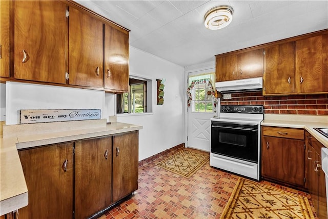 154 Burke Rd, Wharton Twp, PA 15437 - kitchen with range with electric stovetop, under cabinet range hood, light countertops, and brown cabinetry