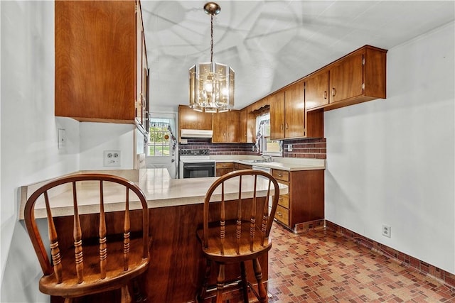 154 Burke Rd, Wharton Twp, PA 15437 - kitchen with range, range hood, a peninsula, light countertops, and decorative backsplash