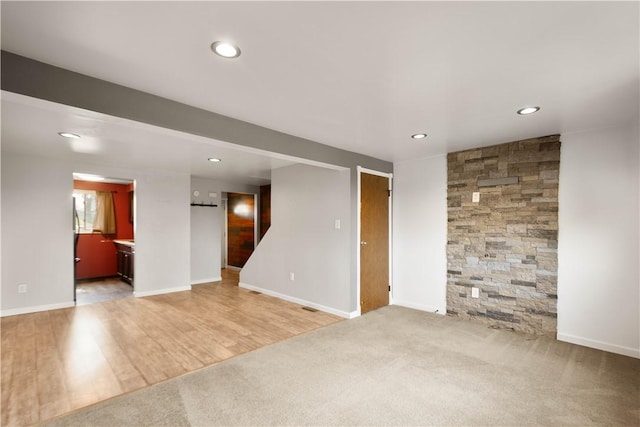 295 Holland Ct, Findlay Twp, PA 15108 - unfurnished living room featuring recessed lighting, light carpet, light wood-style floors, and stairway