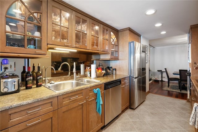 1 Trimont Ln Unit 620B, Mt Washington, PA 15211 - kitchen featuring stainless steel appliances, brown cabinets, light tile patterned floors, recessed lighting, and light stone countertops