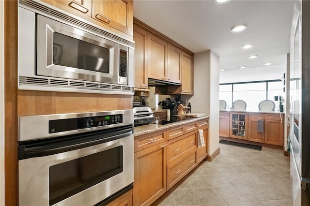 1 Trimont Ln Unit 620B, Mt Washington, PA 15211 - kitchen with appliances with stainless steel finishes, recessed lighting, light tile patterned flooring, and light stone countertops
