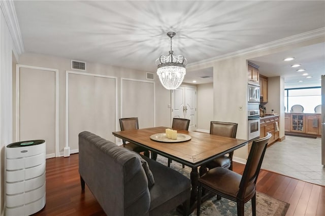 1 Trimont Ln Unit 620B, Mt Washington, PA 15211 - dining area featuring a chandelier, dark wood-style floors, and ornamental molding