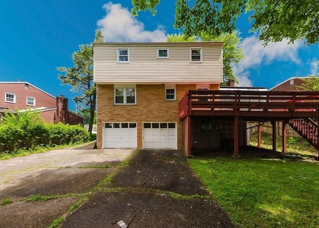 155 Greylock Dr, Penn Hills, PA 15235 - back of property with an attached garage, stairs, asphalt driveway, a wooden deck, and a yard