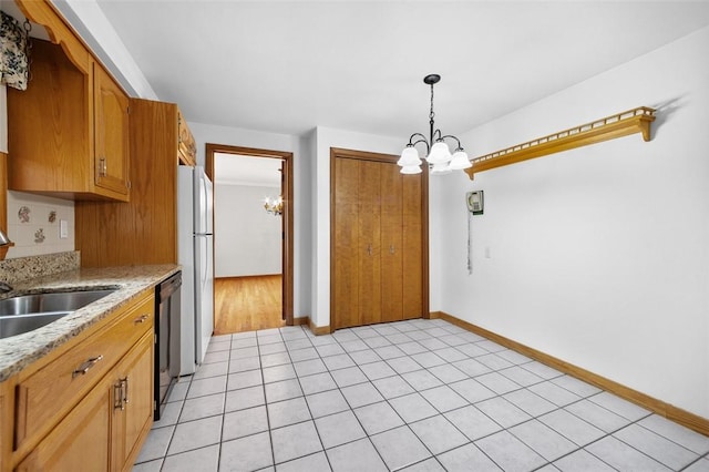 4032 Sardis Rd, Murrysville, PA 15668 - kitchen featuring a chandelier, freestanding refrigerator, brown cabinetry, and pendant lighting