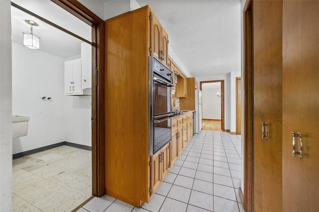 4032 Sardis Rd, Murrysville, PA 15668 - kitchen with freestanding refrigerator, double oven, light countertops, brown cabinetry, and light tile patterned floors