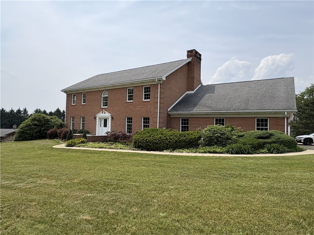 616 Edwards, Derry Twp, PA 15650 - view of front of property featuring a chimney, a front lawn, and brick siding