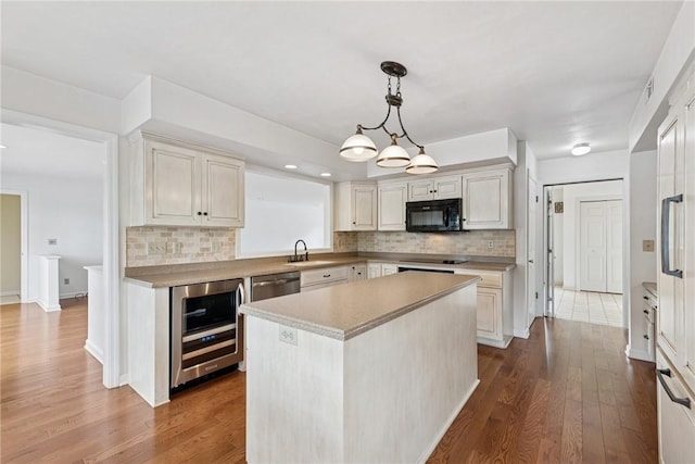 616 Edwards, Derry Twp, PA 15650 - kitchen with black appliances, beverage cooler, a kitchen island, dark wood-style flooring, and decorative backsplash