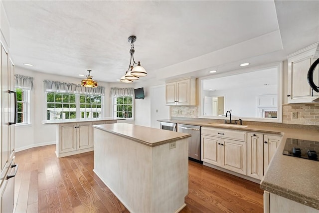 616 Edwards, Derry Twp, PA 15650 - kitchen featuring stainless steel dishwasher, a kitchen island, black electric cooktop, backsplash, and light wood finished floors